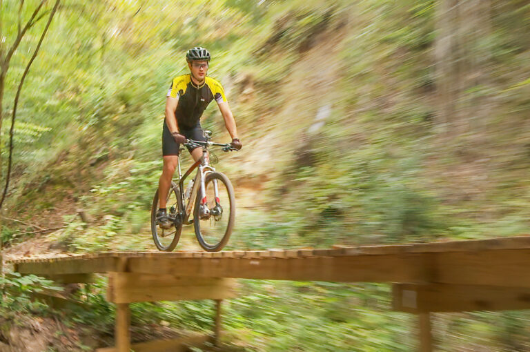 Cyclist on a bridge on The Beast Cycling Trail