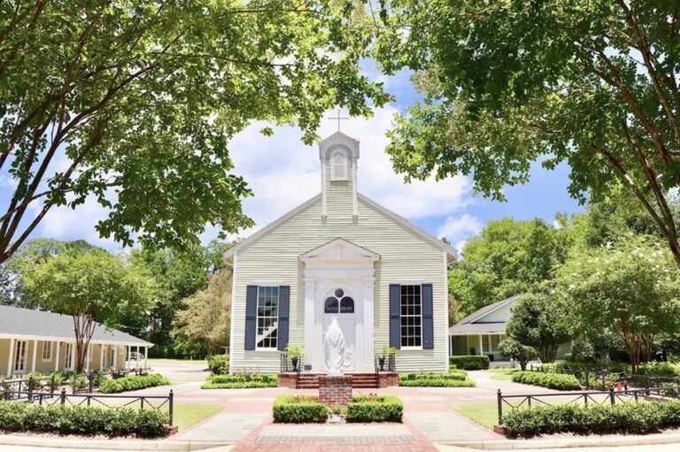 The exterior of Mt. Carmel Catholic Church framed by trees.