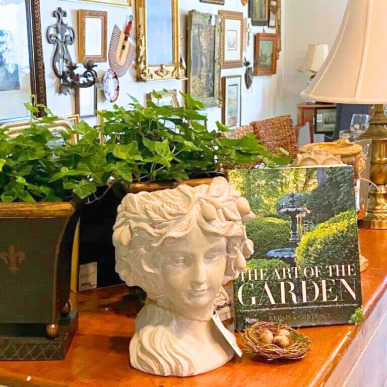Display of statue head and gardening book at Birds of a Feather