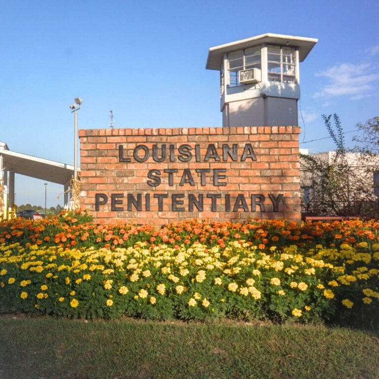 The outdoors sign for Angola Prison reading Louisiana State Penitentiary