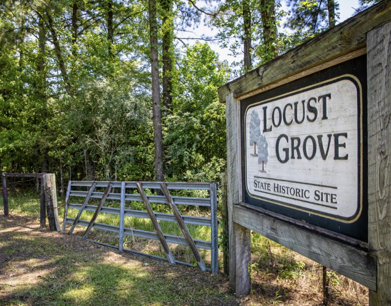 A sign by the entrance for the Locust Grove state historic site.